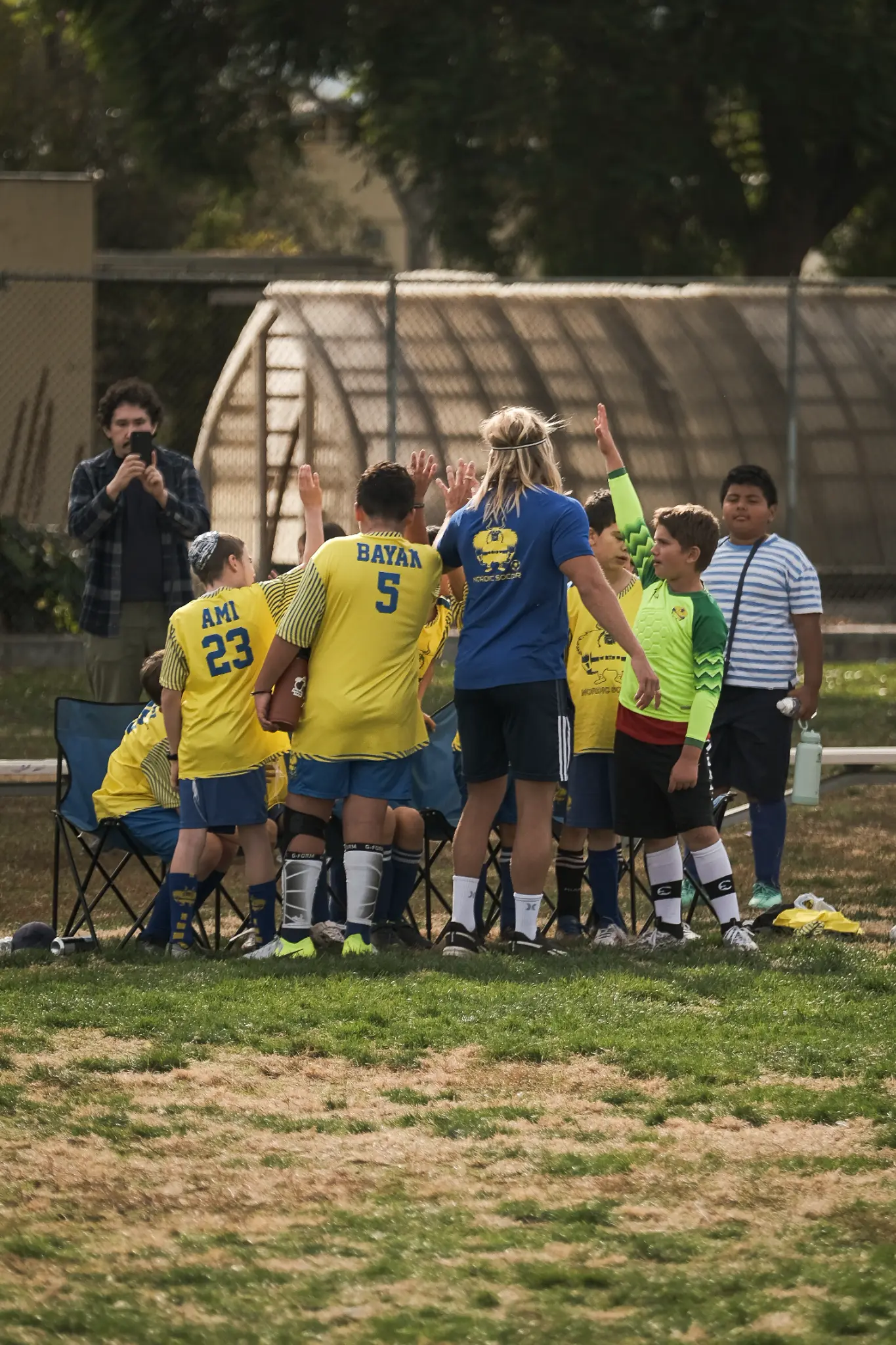 Nordic Soccer coach demonstrating proper shooting technique to young players during training