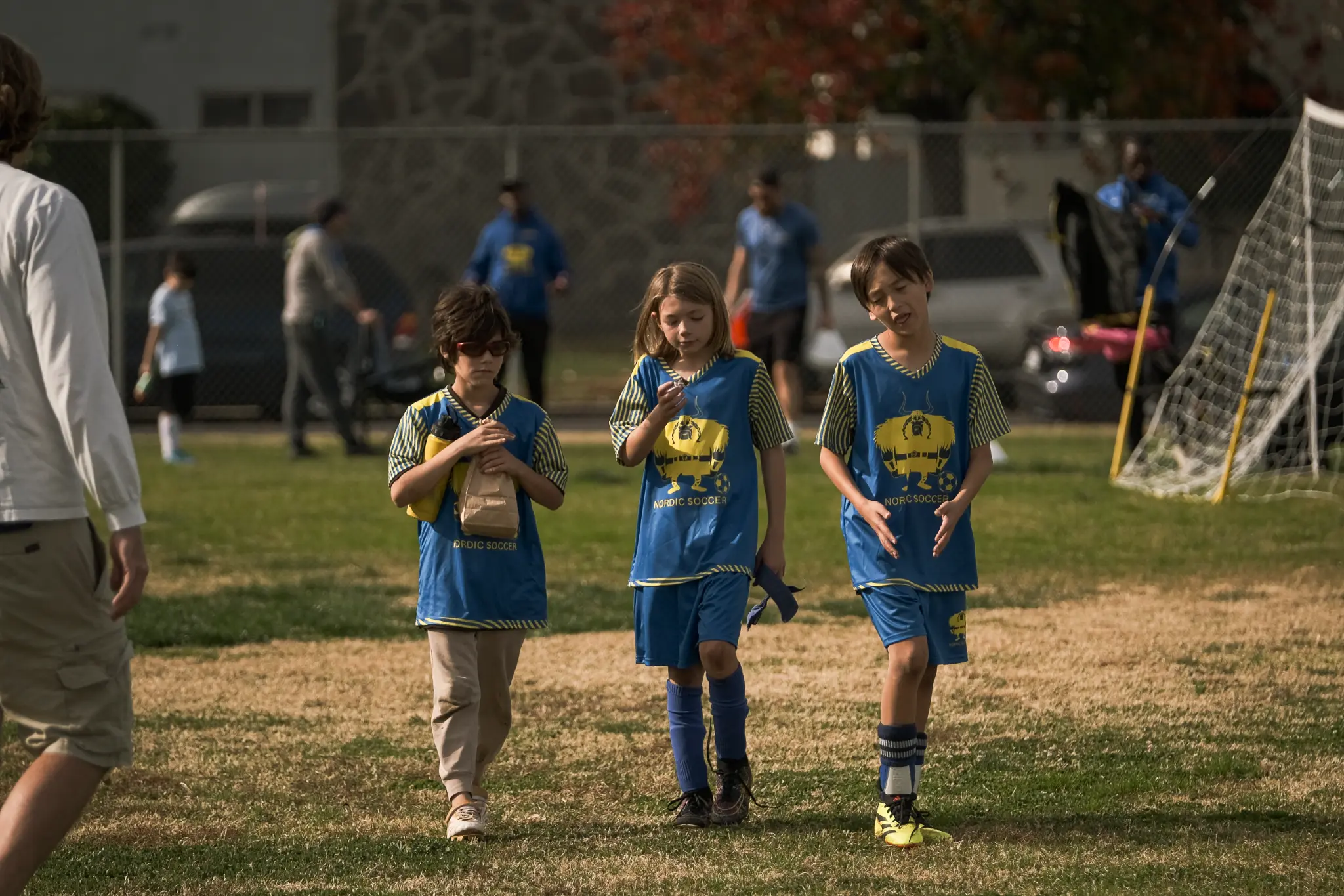 Nordic Soccer players practicing ball control and dribbling skills on grass field in San Fernando Valley